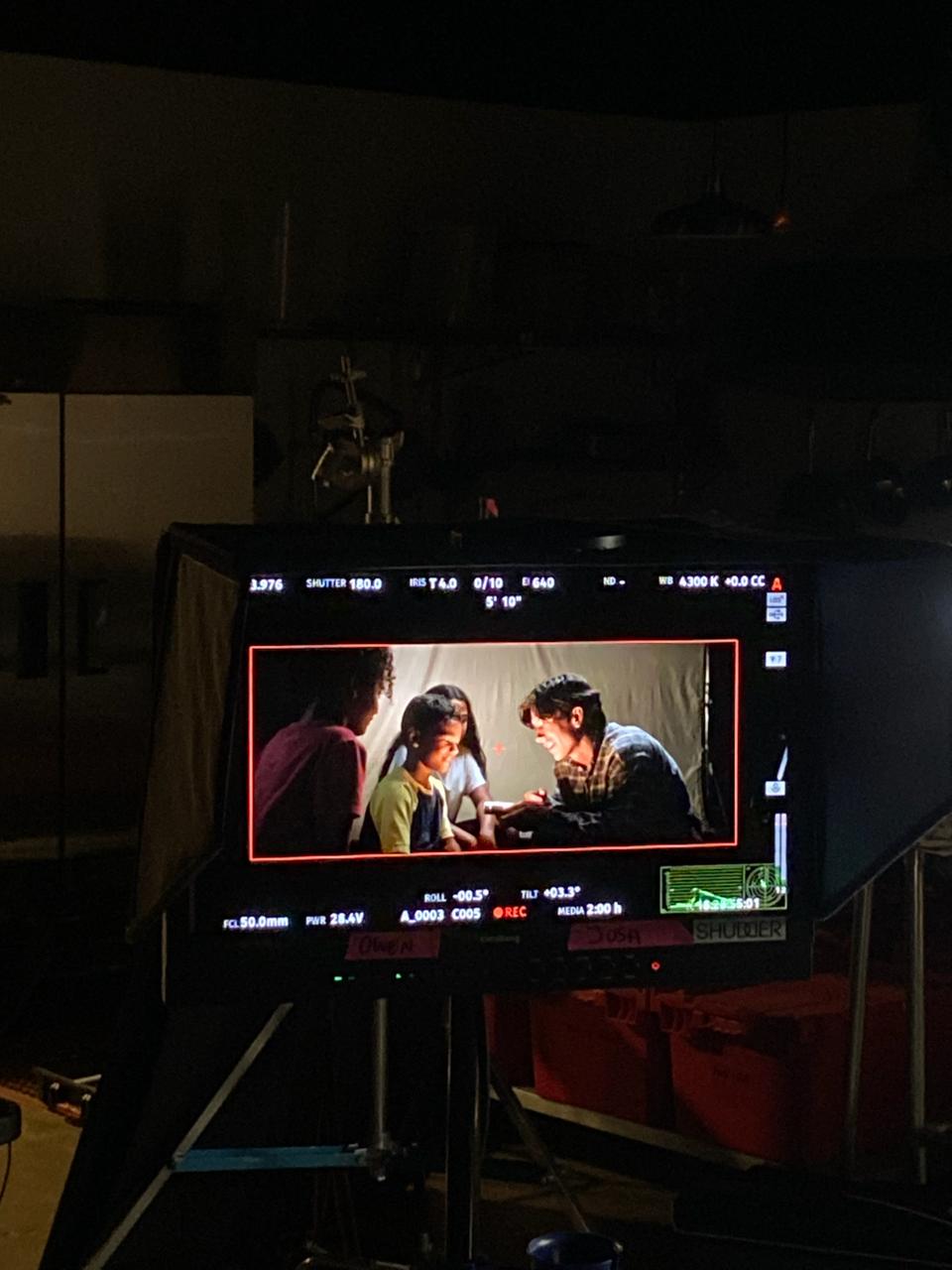 On set, monitor, child actor smiling