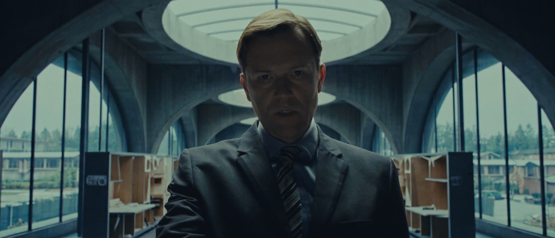 The Meridian CEO in a dark suit beneath the arches